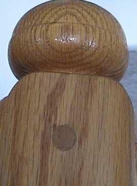 Photo of the top of a newel showing the angles of the nandrails attached to the newel.